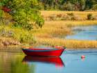 Massachusetts, Cape Cod, West Harwich. Calm water surrounds a red dory moored on the Herring River Art Print